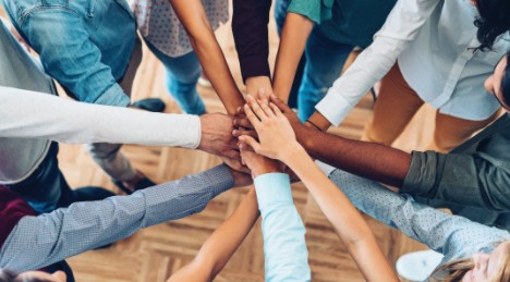 Group of people putting their hands together